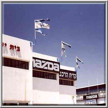 Dilapidated Israeli flags over a plant on Yizhak ...[8 words]... the Middle East, April 25, 2000