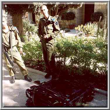 Israeli soldiers with a pile of machine guns at ...[9 words]... the Middle East, January 28, 2001