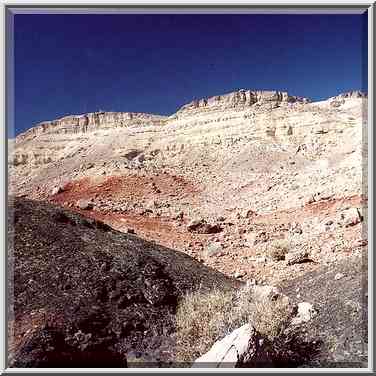 Hills covered by tanned black stones on the ...[20 words]... The Middle East, February 1, 2001