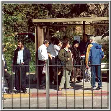 People waiting a bus in Jerusalem. The picture ...[11 words]... lens. The Middle East, March 1, 2001