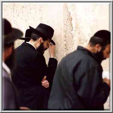 Old City, worshipers at Western Wall at evening. Jerusalem, the Middle East, March 1, 2001