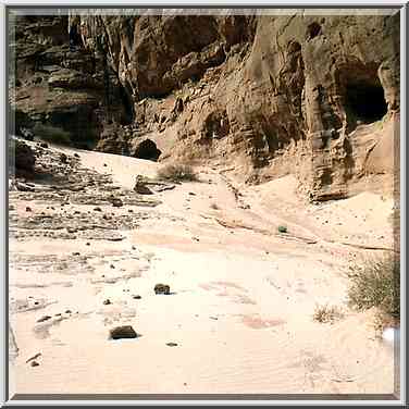 White sand and caves at the foot of Timna cliffs ...[5 words]... Eilat. The Middle East, April 25, 2001