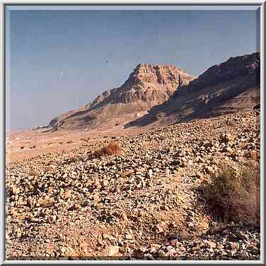 View of a hill with Masada fortress on the top ...[10 words]... evening. The Middle East, May 10, 2001