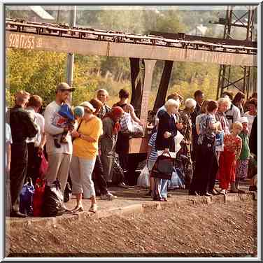 Passengers waiting a local train at a railroad ...[5 words]... Cheliabinsk. Russia, August 15, 2001